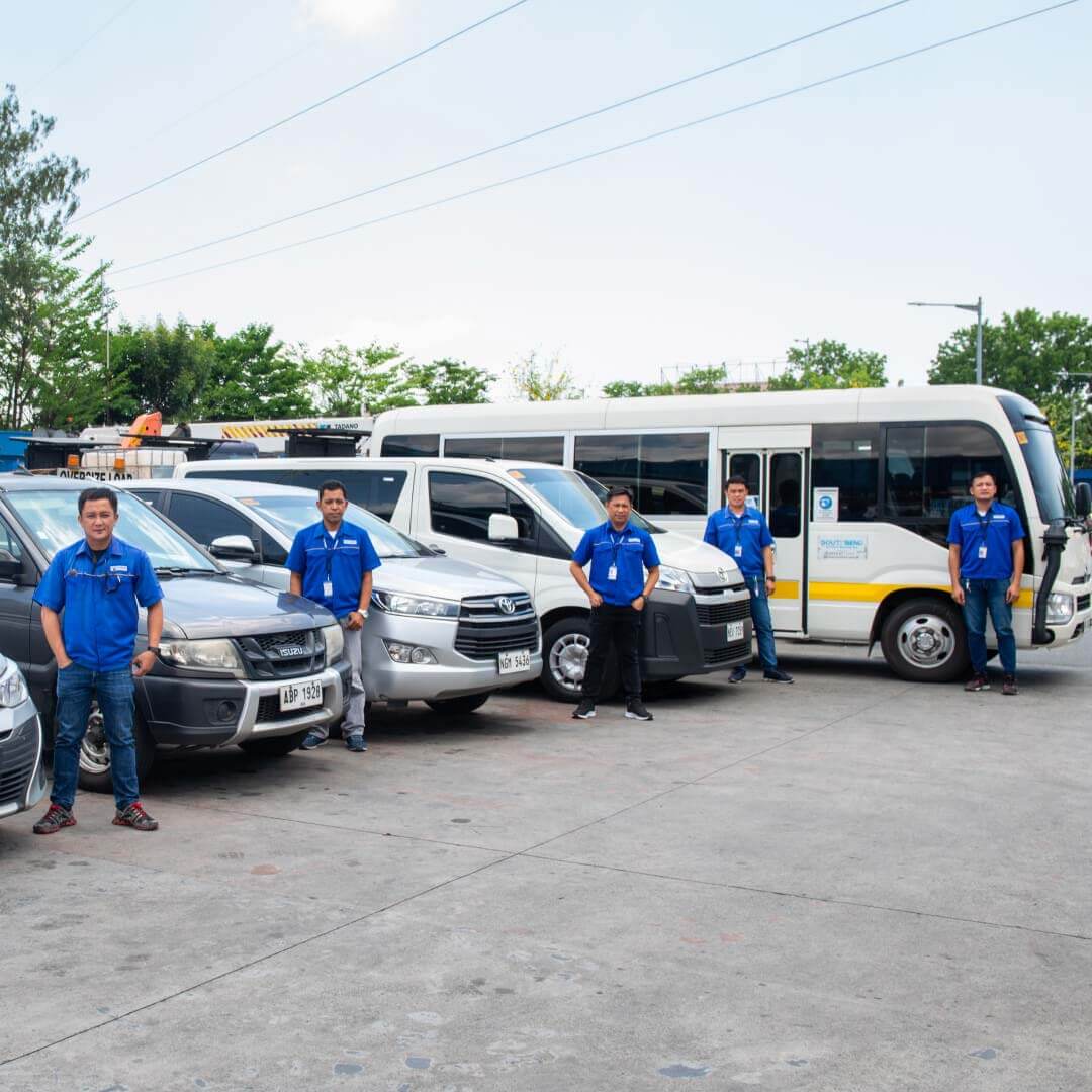 People standing beside cars